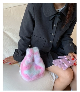 Detail view of pink plaid faux fur chain bag with coordinating lavender knit gloves