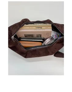 Detail view of large brown suede dumpling bag interior showing spacious storage capacity