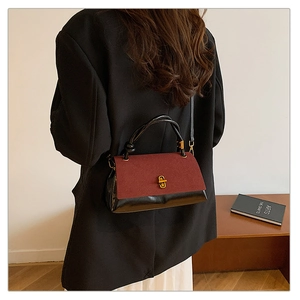 Model wearing a vintage contrast crossbody bag with burgundy flap and black leather body