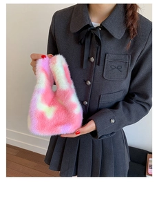 Detail of pink and white tie-dye plush handbag featuring soft faux fur texture and handle