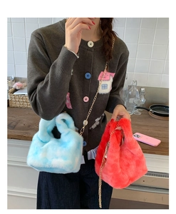 Detail of plush faux fur chain bags in blue clouds and red for autumn and winter style