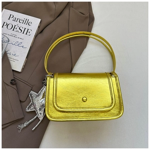 Detail of metallic bright yellow small square handbag with silver star charm and double handles