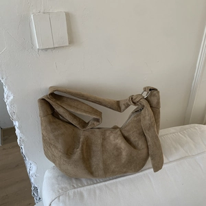 Vintage brown suede hobo bag with knotted strap detail and spacious crescent shape