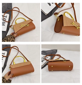 Detail view of brown PU leather handbag with beige woven texture and gold metal handle