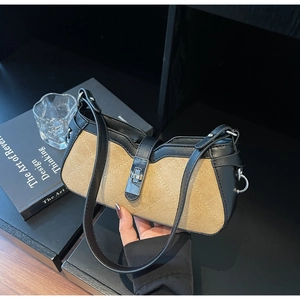 Detail of color-block baguette bag with diamond stitching and silver metal clasp