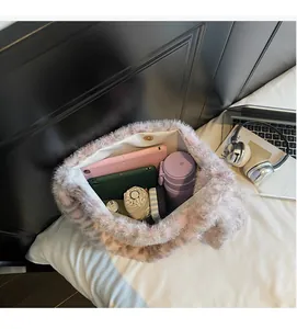 Spacious interior of plush faux fur tote bag holding a tablet, bottle, and umbrella