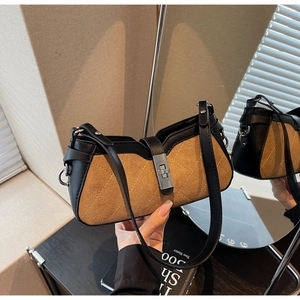 Detail of suede crossbody bag with rhombus stitching and silver twist lock closure