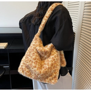 Detailed view of fluffy leopard print faux fur tote bag with wide shoulder strap