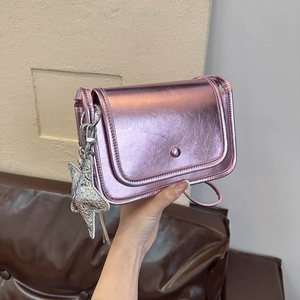 Metallic purple crossbody bag with star pendant and silver magnetic flap closure