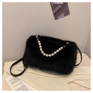 Detail of black faux fur shoulder bag with elegant white pearl chain and gold hardware