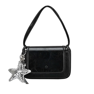 Minimalist black shiny leather crossbody square bag with a silver star charm accessory