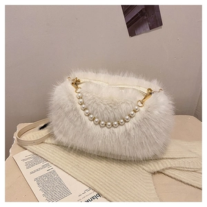Detail of white plush shoulder bag with decorative faux pearl chain and gold-tone hardware