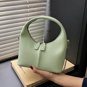 Minimalist light green faux leather handbag with sleek chain strap and arch handle