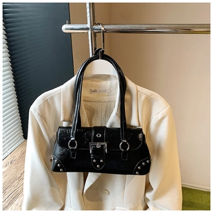 Detail of glossy black crinkle leather shoulder bag with silver buckle and hardware