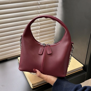 Burgundy PU leather handbag with semicircular handle and silver chain strap