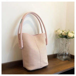 Détail de la texture tissée et poignée en cuir rose avec décoration en tube métallique