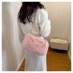 Detail showing soft pink faux fur texture and elegant white pearl chain on shoulder bag