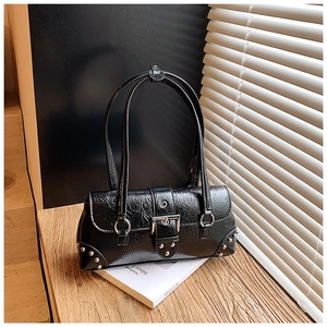 Detailed shot of vintage black crinkled leather shoulder bag with silver buckle and rivets