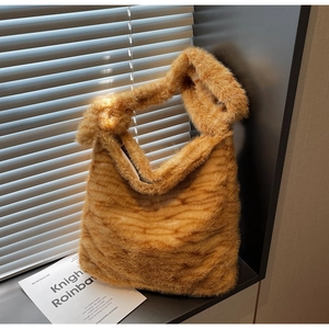 Detailed texture of fluffy orange tiger print tote bag made of soft faux fur fabric