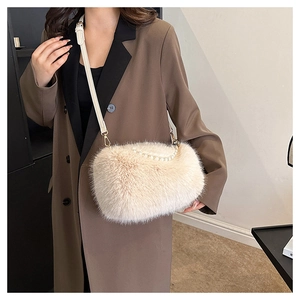 Detail of plush crossbody bag featuring a pearl handle and soft faux fur texture