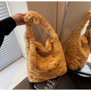 Detail showing plush faux fur texture and tiger stripes on a soft shoulder bag