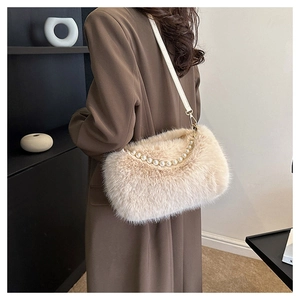 Detailed texture of beige faux fur shoulder bag with elegant white pearl handle details