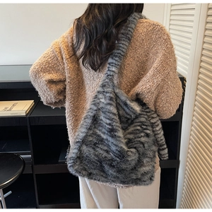 Detail of soft striped faux fur tote bag showing the plush texture and large capacity