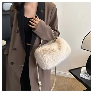 Chic beige faux fur shoulder bag with pearl chain strap worn with a brown coat