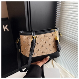 Detail of embroidered khaki suede and black leather crossbody bag with sparkling rhinestones