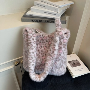 Close-up of pink leopard print plush tote bag showing soft faux fur texture and wide strap