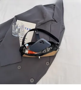 Interior view showing capacity for a smartphone, lipstick, and perfume in a baguette bag