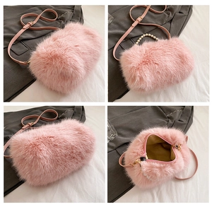 Detail view of pink faux fur bag featuring pearl handle and yellow fabric lining
