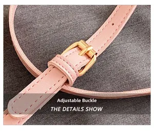 Close-up of pink leather strap with adjustable golden metal buckle and neat stitching