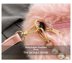 Detail of pink faux fur bag with gold hardware, detachable strap, and pearl charm