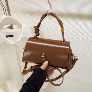 Brown glossy patent leather handbag with gold twist lock and stylish knotted handle
