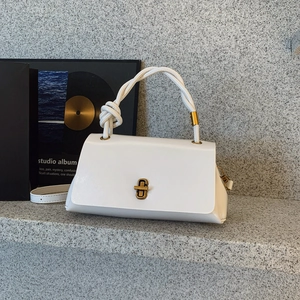 Glossy white faux leather handbag with braided handle and gold twist-lock closure