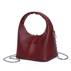 Chic dark red leather handbag with unique round handle and silver chain strap details