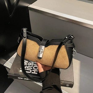 Brown and black baguette shoulder bag with quilted texture and silver twist lock
