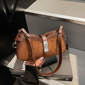 Brown quilted baguette shoulder bag with matte texture and silver twist lock