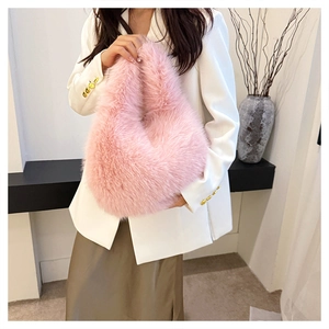 Close-up of fluffy pink faux fur handbag styled with elegant white professional blazer