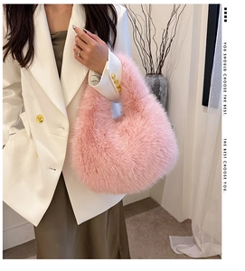 Close-up of pink faux fur hobo bag showing fluffy texture and minimalist handle design