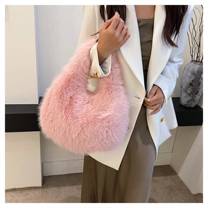 Close-up of pink faux fur hobo bag showing soft texture and half-moon silhouette