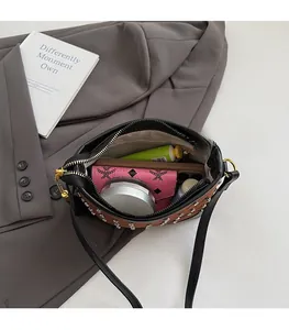 Detailed view of the brown quilted crossbody bag interior holding a phone and wallet