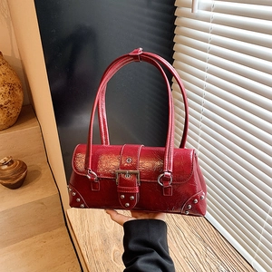 Chic red patent leather underarm bag with vintage silver buckles and rivets detail