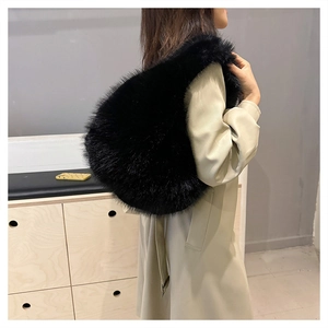 Close-up of black faux fur shoulder bag texture and plush material on model