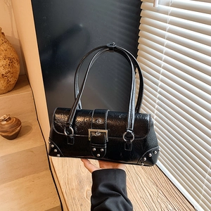 2025 retro black faux leather handbag with silver buckle and studs in artistic setting