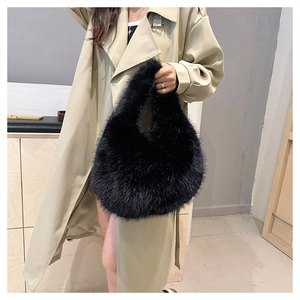 Close-up of black faux fur handbag paired with a beige trench coat for autumn style