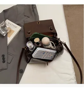 Interior view of brown vintage leather bag showing zipper pocket and spacious capacity