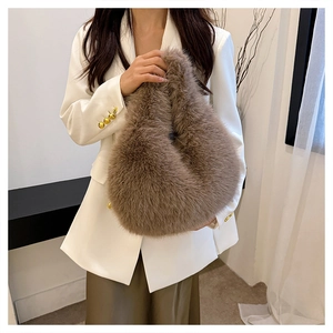 Close-up of fluffy brown faux fur handbag styled with a white blazer and green dress