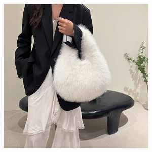 Close-up of plush white faux fur handbag texture and soft arc structure design